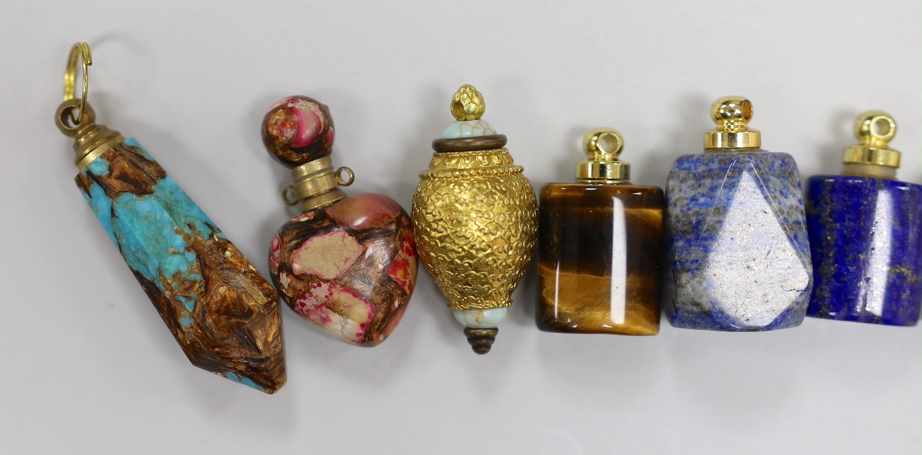 Eleven assorted gilt metal mounted hardstone and semi-precious stone small scent bottles, including Tiger's eye, rose quartz, lapis lazuli and amethyst.